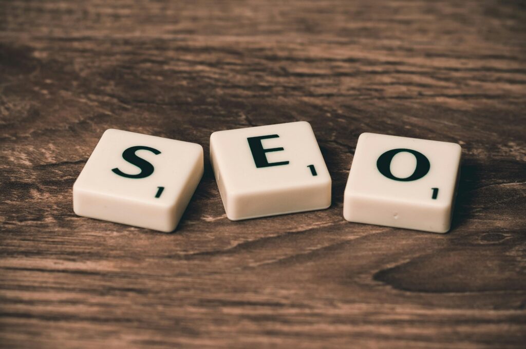 Search Engine Optimization concept represented by SEO letter tiles on a wooden desk, symbolizing website ranking and digital marketing strategy.